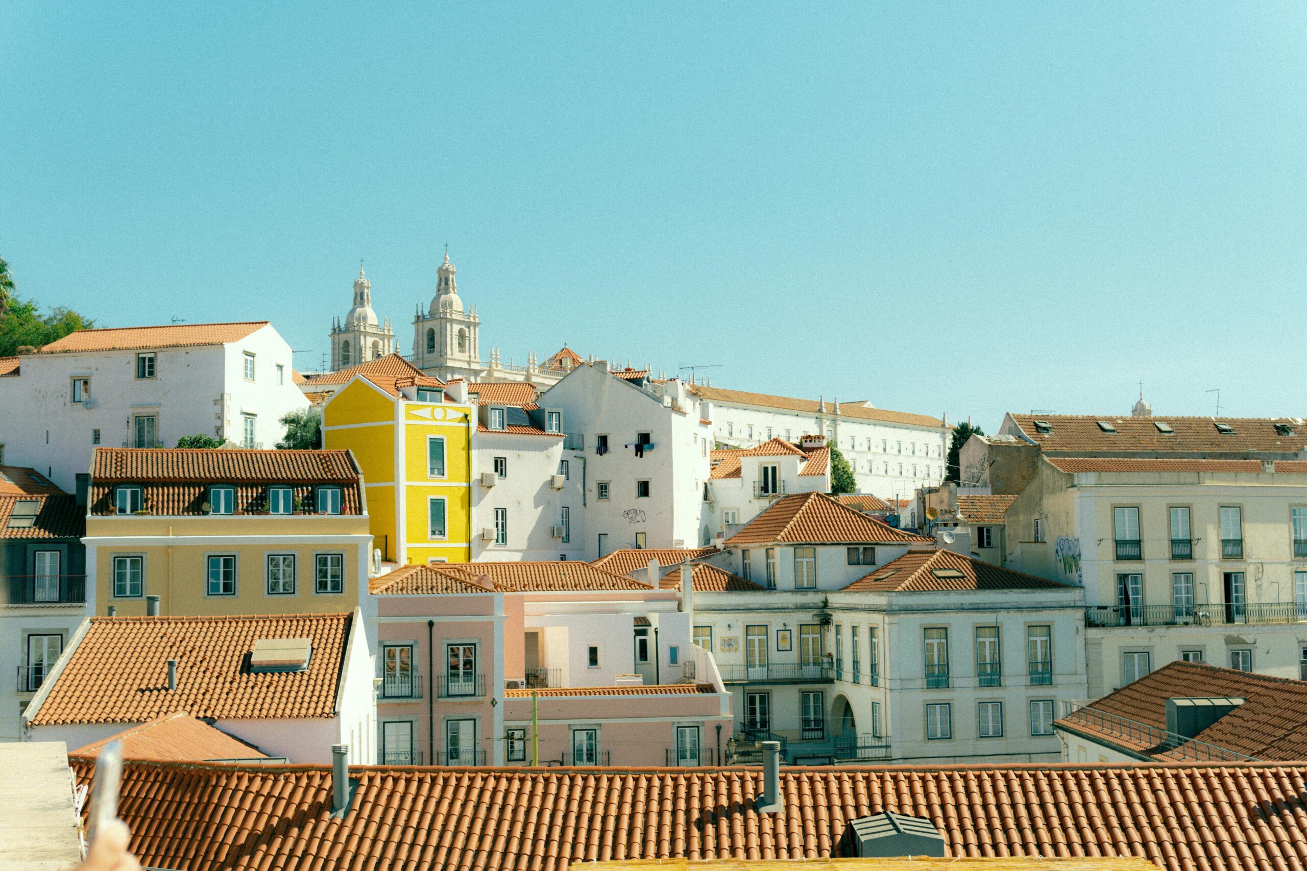 Charming rooftops of Lisbon with a view of historic architecture on a sunny day.